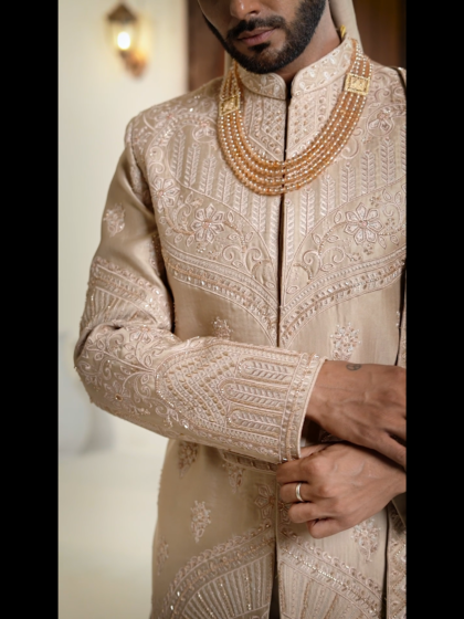 A luxurious beige embroidered sherwani